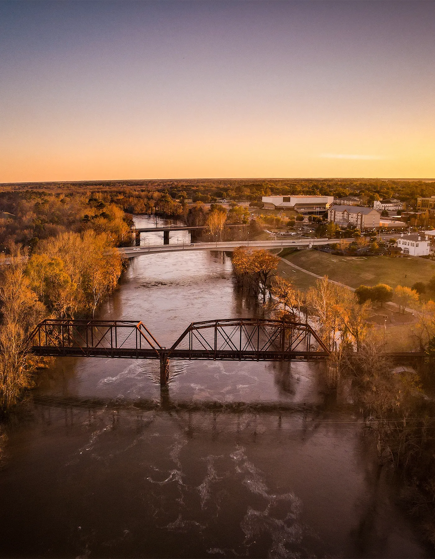 train tracks and bridge at sunset